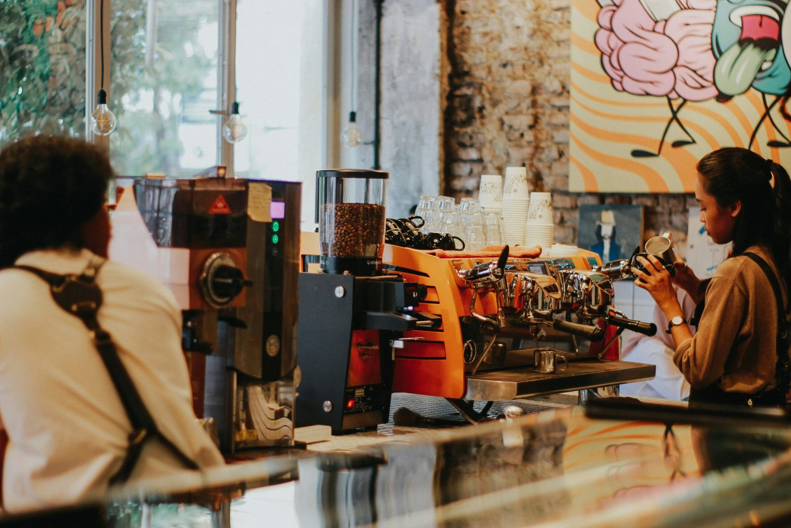 a woman is sitting at a coffee shop